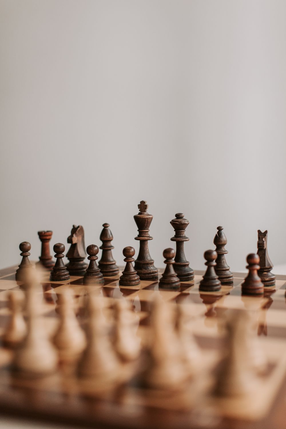 A wooden chess set on a chessboard